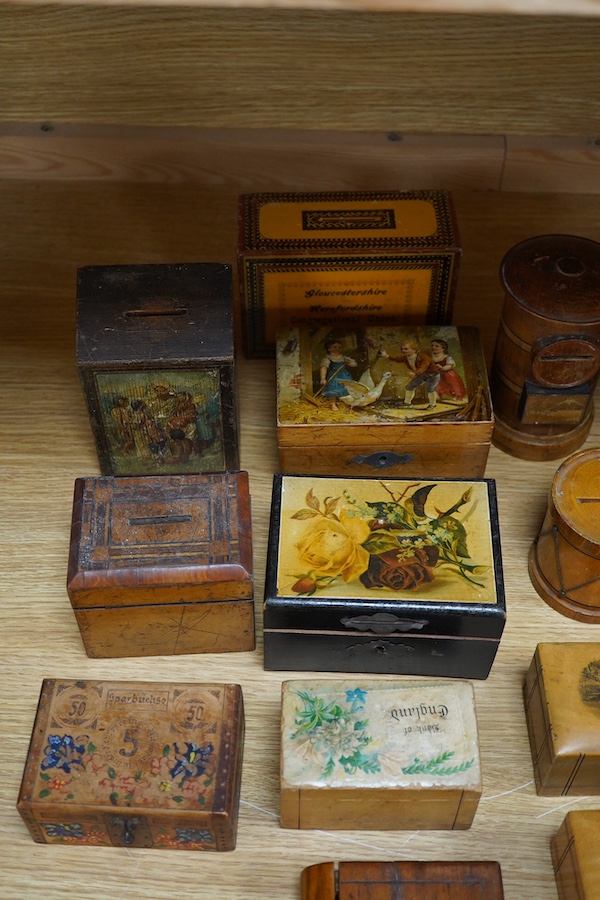 A 19th century Tunbridgeware tea caddy, 20cm wide, 11cm high, a Coquilla nut miniature money box and a collection of mixed decorative and novelty wooden money boxes (17). Condition - poor to fair